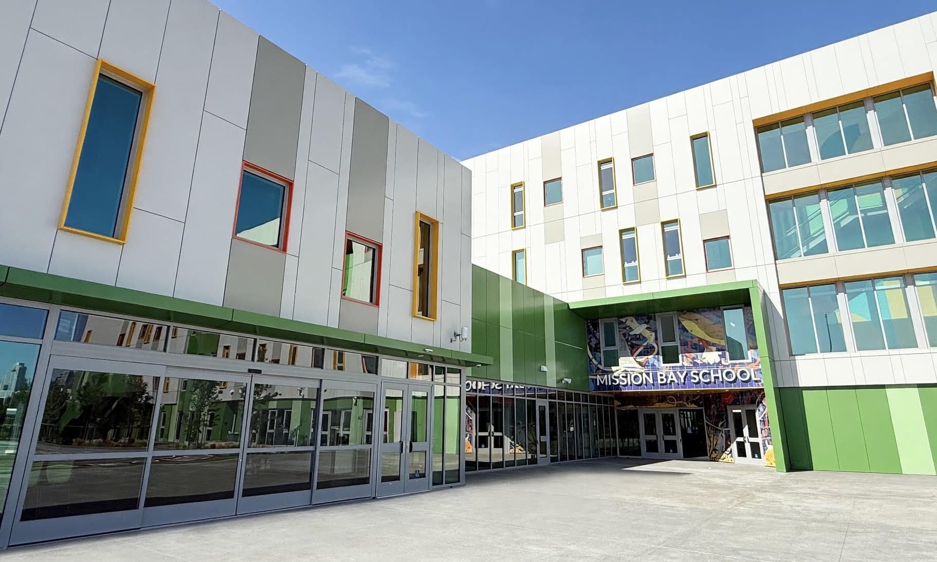Mission Bay School's finished entrance courtyard, with the school's name in tile above the main doors